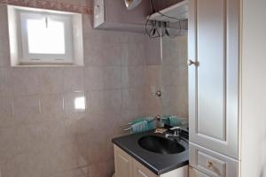 a bathroom with a black sink and a window at Rosalie in Masléon +5 photos