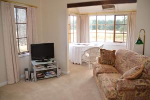 a living room with a couch and a tv at Buttons Cottage for September baby lambs in Nietta