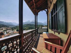 a balcony with benches and a view of the mountains at Rottenhöfer Retreat Villa in Berchtesgaden