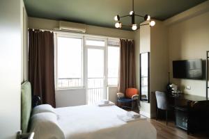 a hotel room with a bed and a large window at Corso Italia Rooms in Milan