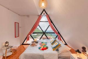 a bedroom with a bed with a large window at Mon Mon Homestay in Mon Jam +30 photos
