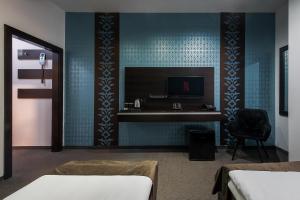 a bedroom with a desk and a chair in a room at Hotel Polo in Prešov