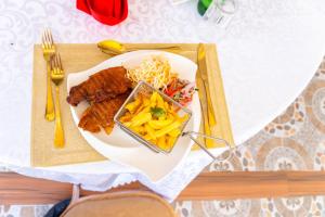a plate of food with meat and vegetables on a table at Arise Sunshine Hotel in Narok