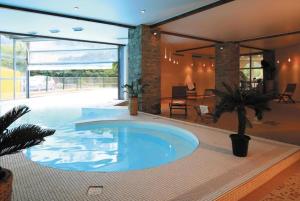 a large swimming pool in the middle of a house at Douce Altitudes Cauterets in Cauterets