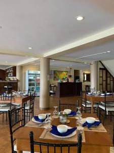 a large dining room with wooden tables and chairs at Sierra Resort in Dauin