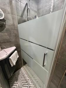 a bathroom with a shower and a bath tub at L'Escale à Villerville in Villerville +5 photos