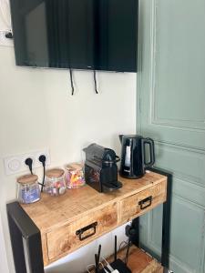 a wooden table with a microwave on top of it at L'Escale à Villerville in Villerville