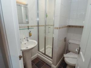 a bathroom with a shower and a toilet and a sink at 1 Park Road in Windermere +72 photos
