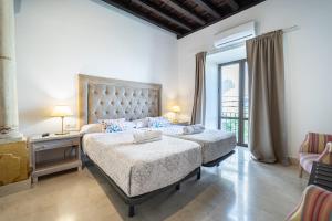 a bedroom with two beds and a large window at GAV Santa Pola in Ronda
