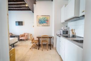 a kitchen with a table and a microwave at GAV Santa Pola in Ronda
