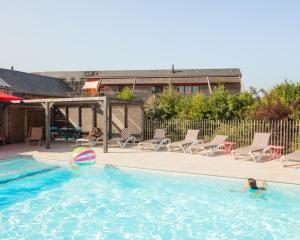 a swimming pool with a volley ball and chairs at Le jardin des 4 saisons in Le Mans +151 photos