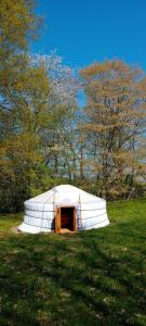 a large white tent in a field of grass at La Yourte Gasconne in Estampures