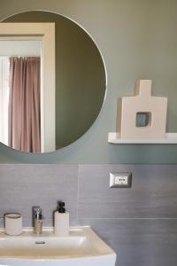 a bathroom with a sink and a mirror at Corso Italia Rooms in Milan