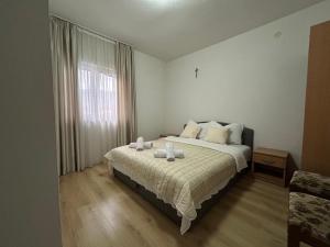 a bedroom with a bed with two candles on it at Maća i Ante Pavlović in Međugorje