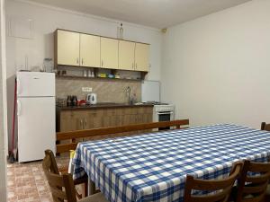 a kitchen with a table and a white refrigerator at Maća i Ante Pavlović in Međugorje +14 photos