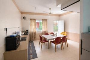 a kitchen and dining room with a table and chairs at Rex Zone Homestay in Bedung