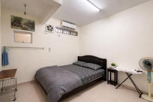 a bedroom with a bed in a white room at Rex Zone Homestay in Bedung