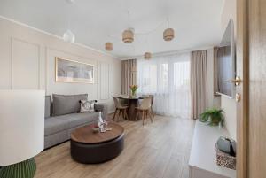 a living room with a couch and a table at Marina Apartament Old Town View in Kamień Pomorski