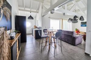 a living room with a table and a couch at Only4View rooftop Sainte-Anne in Sainte-Anne