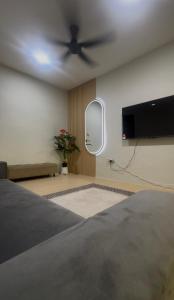 a bedroom with a bed and a ceiling fan at AH Homes Kulai in Kulai