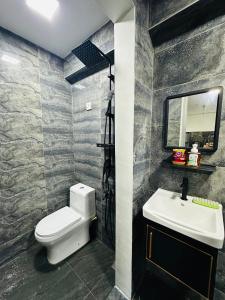 a bathroom with a white toilet and a sink at AH Homes Kulai in Kulai