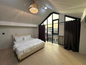 a bedroom with a bed and a large window at AH Homes Kulai in Kulai