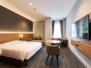 a hotel room with a bed and a flat screen tv at SUPER HOTEL HANOI - Grand Opening in 17 March 2026 in Hanoi