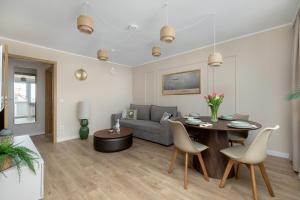 a living room with a table and a couch at Marina Apartament Old Town View in Kamień Pomorski +27 photos