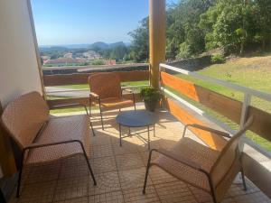 four chairs and a table on a balcony with a view at Quinta da Vigia in Angra do Heroísmo +38 photos