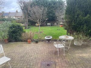 a patio with a table and chairs in a yard at Caterine lodge in Whetstone