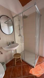 a bathroom with a shower and a sink and a stool at Casa Rural La Font in Sant Mateu +24 photos