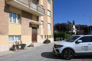 a white car parked in front of a building at S357 - Sirolo, luminoso trilocale con posto auto in Sirolo +4 photos