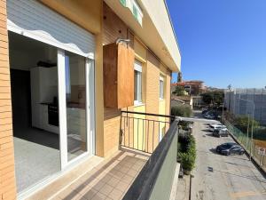 a balcony of a house with an open door at S357 - Sirolo, luminoso trilocale con posto auto in Sirolo