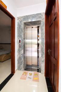 a walk in shower in a room with a door at White Horse Homestay in Hue