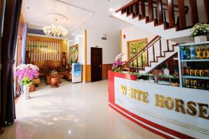 a shop with a white horse sign on the counter at White Horse Homestay in Hue