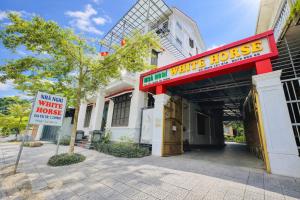 a building with a sign that reads main street white house at White Horse Homestay in Hue