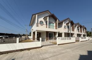 a row of houses with a white fence at House in HangDong in Hang Dong