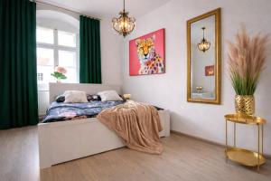 a bedroom with a bed and a painting of a tiger at Old Town Studio - Stay Olomouc CZ in Olomouc +4 photos