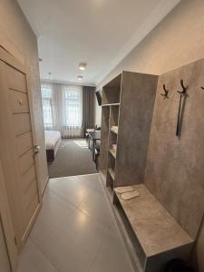a room with a bed and a room with a closet at Khan Boutique Hotel in Almaty +67 photos