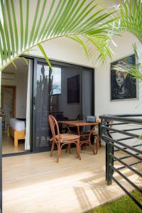 a patio with a wooden table and chairs at Saphir Boutique Hotel in Kigali