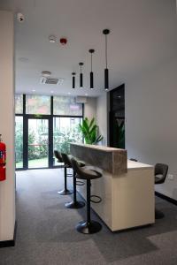an office lobby with a counter and stools at Santa5 hostel in Vlorë