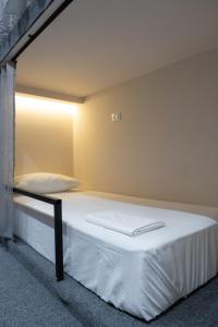 a bed in a room with a light on it at Santa5 hostel in Vlorë +79 photos