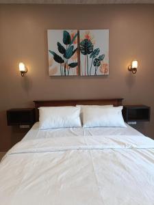 a bed with two pillows and two paintings on the wall at Meneth Villa in Hatton +13 photos