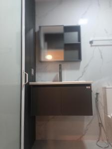 a kitchen with a sink and a microwave at Meneth Villa in Hatton