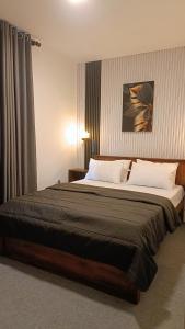 a bedroom with a large bed in a room at Meneth Villa in Hatton