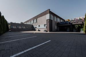 an empty parking lot in front of a building at Hotel Polo in Prešov