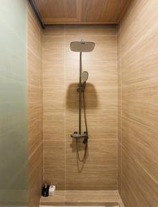 a bathroom with a shower with a light fixture at Zenora Homestay in Khu Chi Lăng