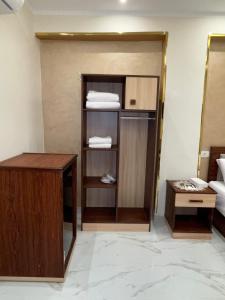 a room with a closet with a desk and towels at Pr Pyramids Inn in Cairo +38 photos