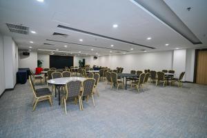 a conference room with tables and chairs and a podium at Kingston Hotel 15 - Tower Regency, Ipoh in Ipoh