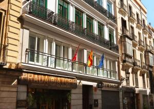 a building with flags on the side of it at Limehome Madrid Sol in Madrid